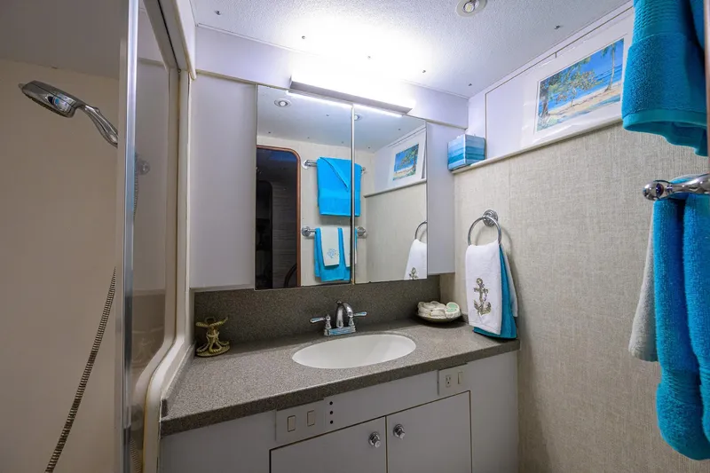 Members Only Yacht Photos Pics Luxurious bathroom in 2001 Ocean Yachts Super Sport, featuring modern fixtures and nautical decor.