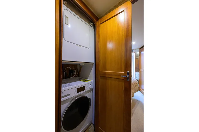 Members Only Yacht Photos Pics Laundry area with stacked washer and dryer in 2001 Ocean Yachts Super Sport.