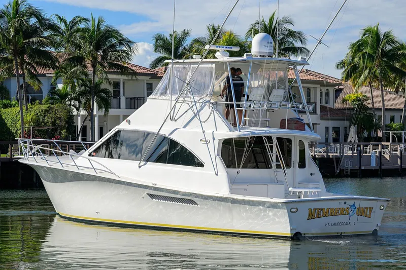 Members Only Yacht Photos Pics 2001 Ocean Yachts Super Sport boat docked near waterfront homes, surrounded by palm trees.