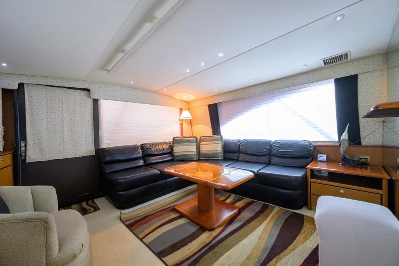 Members Only Yacht Photos Pics Luxurious interior of 2001 Ocean Yachts Super Sport with leather seating and wooden table.