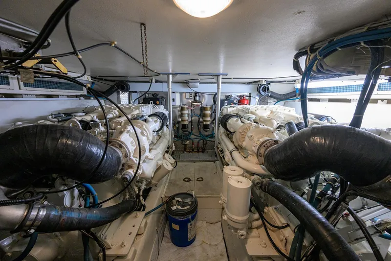 Members Only Yacht Photos Pics Engine room of a 2001 Ocean Yachts Super Sport, showcasing dual engines and mechanical components.