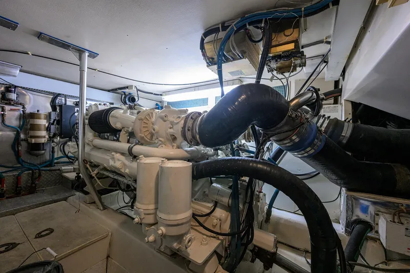 Members Only Yacht Photos Pics Engine room of a 2001 Ocean Yachts Super Sport, showcasing complex machinery and piping.