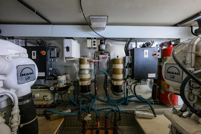 Members Only Yacht Photos Pics Engine room of a 2001 Ocean Yachts Super Sport, featuring MAN equipment and complex piping.
