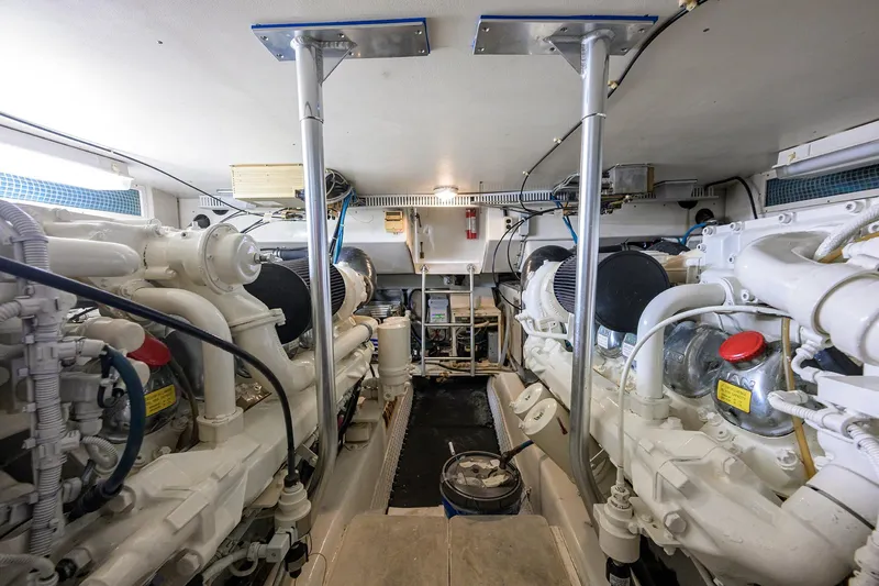 Members Only Yacht Photos Pics Engine room of a 2001 Ocean Yachts Super Sport, showcasing dual engines and mechanical components.
