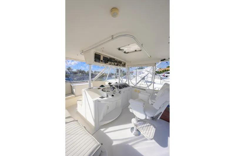 Members Only Yacht Photos Pics 2001 Ocean Yachts Super Sport helm with white seating and panoramic windows.
