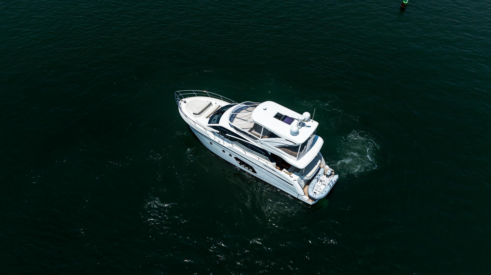 Aerial view of 2017 Absolute 50 Fly yacht cruising on open water.