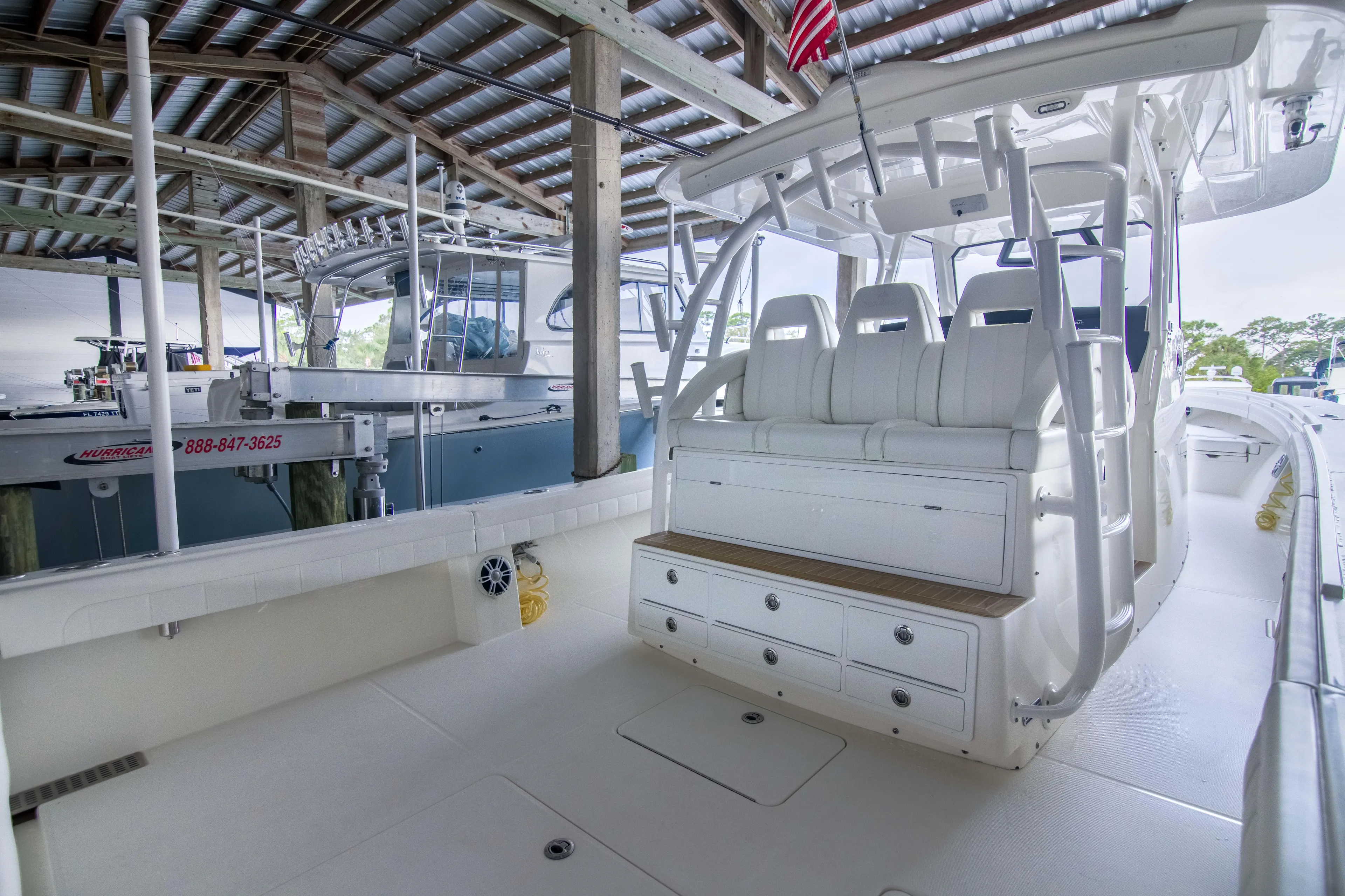 Miss Megan Yacht Photos Pics 2021 Regulator 41 boat interior with seating and storage under covered dock.