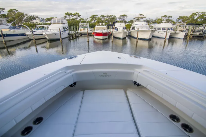 Miss Megan Yacht Photos Pics Bow view of 2021 Regulator 41 boat docked among other yachts in a marina.