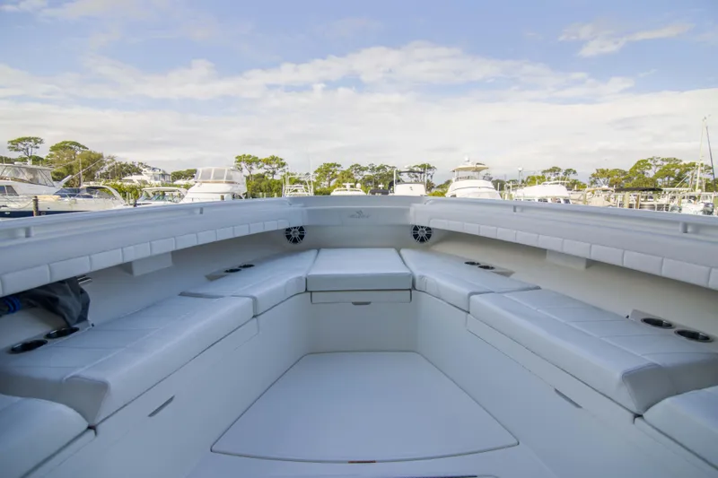 Miss Megan Yacht Photos Pics Spacious seating area on 2021 Regulator 41 boat, docked at marina under blue sky.