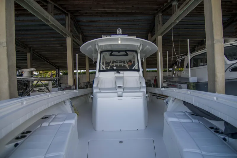 Miss Megan Yacht Photos Pics 2021 Regulator 41 boat in covered dock, showcasing spacious deck and seating.