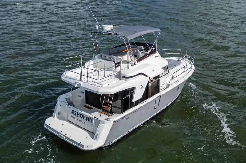 Ashokan Yacht Photos Pics 2022 Beneteau Swift Trawler 35 cruising on open water, rear view.