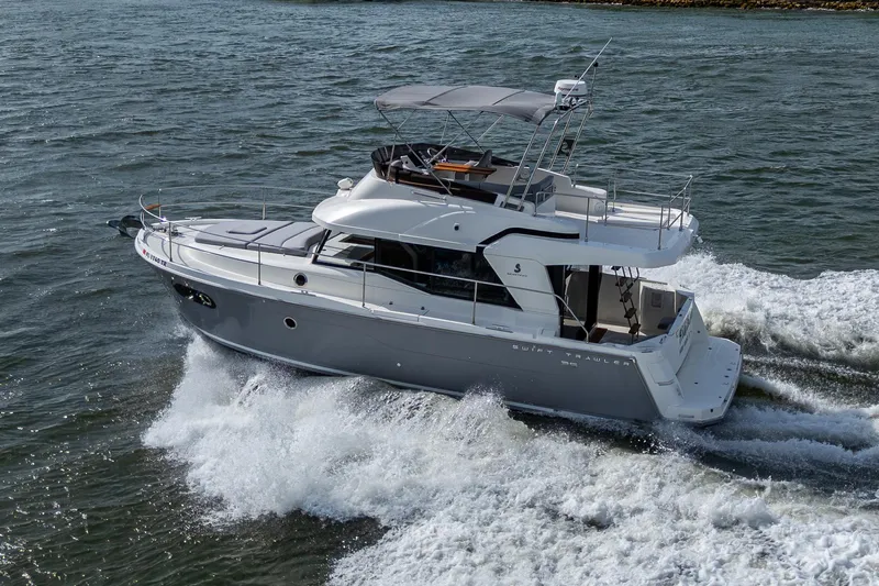 Ashokan Yacht Photos Pics 2022 Beneteau Swift Trawler 35 cruising on open water, showcasing sleek design and performance.