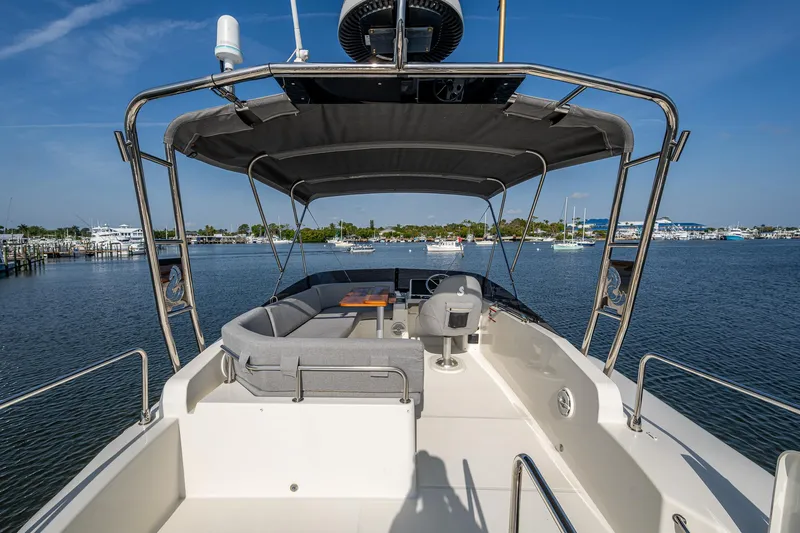 Ashokan Yacht Photos Pics 2022 Beneteau Swift Trawler 35, spacious deck with seating, docked in a serene marina.