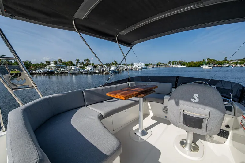 Ashokan Yacht Photos Pics 2022 Beneteau Swift Trawler 35 interior with seating and table, overlooking marina.