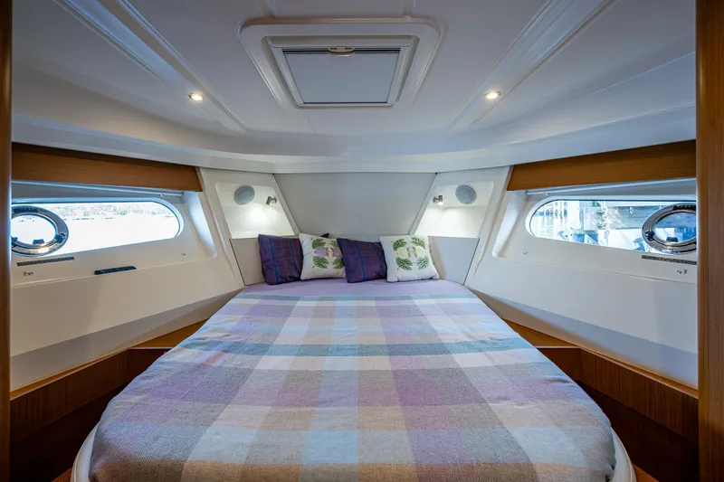 Ashokan Yacht Photos Pics Luxurious cabin interior of 2022 Beneteau Swift Trawler 35 with cozy bedding.
