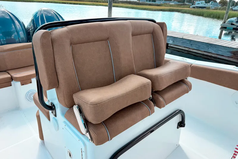  Yacht Photos Pics 2023 Sea Hunt Ultra 275 SE boat seating with brown cushions, dockside view.
