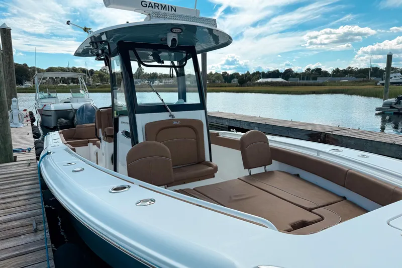  Yacht Photos Pics 2023 Sea Hunt Ultra 275 SE boat docked by a scenic waterfront.