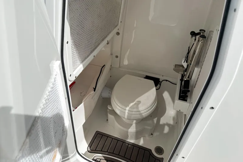  Yacht Photos Pics 2023 Sea Hunt Ultra 275 SE boat interior with compact marine toilet.