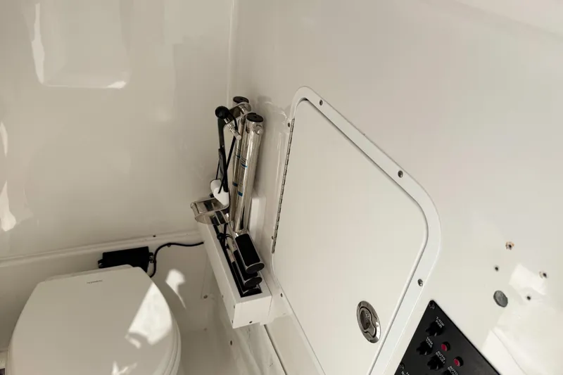  Yacht Photos Pics 2023 Sea Hunt Ultra 275 SE boat interior with toilet and storage compartment.