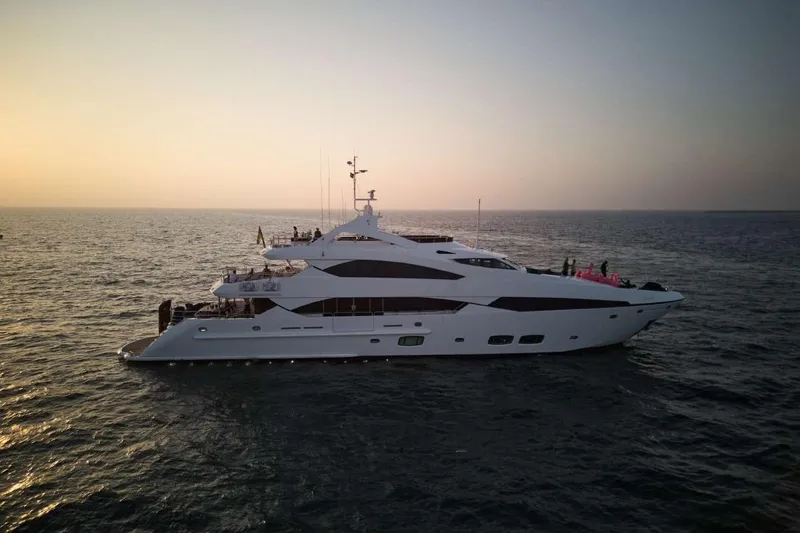  Yacht Photos Pics Luxurious 2010 Sunseeker 131 Yacht cruising at sunset on open sea.