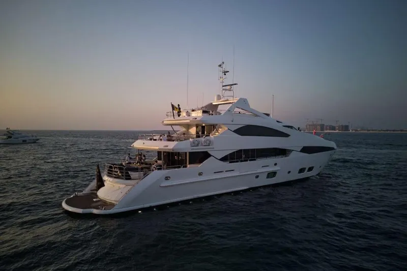  Yacht Photos Pics Luxurious 2010 Sunseeker 131 Yacht cruising at sunset on open water.