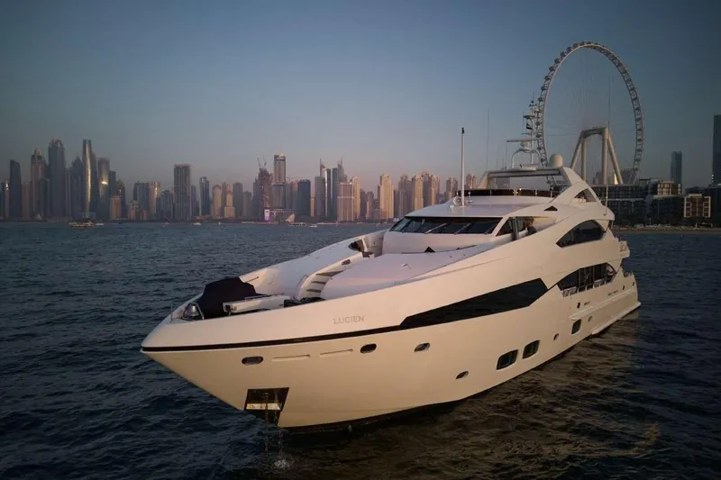  Yacht Photos Pics Luxurious 2010 Sunseeker 131 Yacht cruising near a city skyline at sunset.