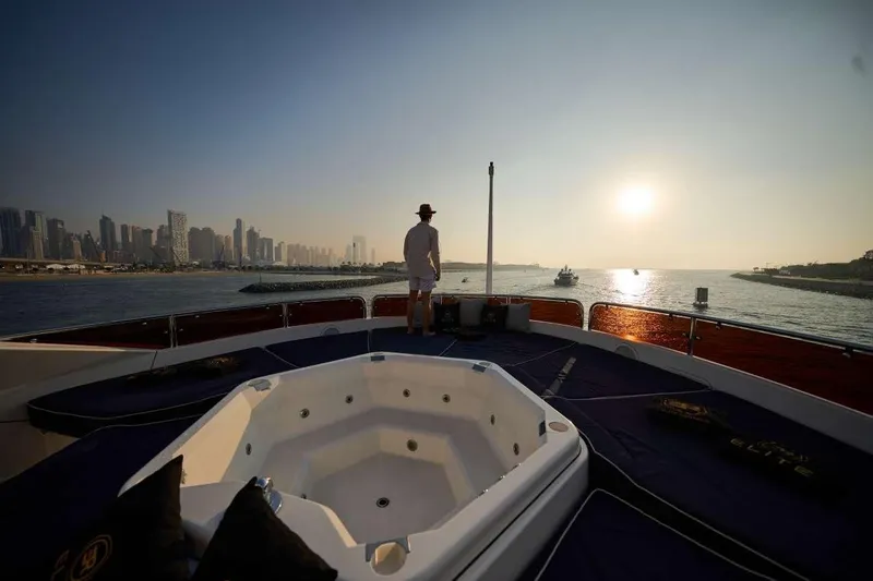 Yacht Photos Pics Person on Sunseeker 131 Yacht, 2010, enjoying sunset view over city skyline.