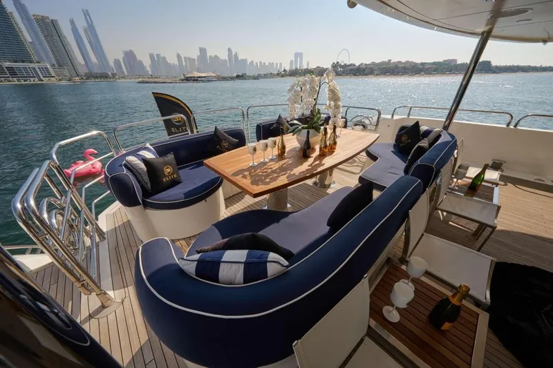  Yacht Photos Pics Luxurious Sunseeker 131 Yacht deck with elegant seating, table, and city skyline view.