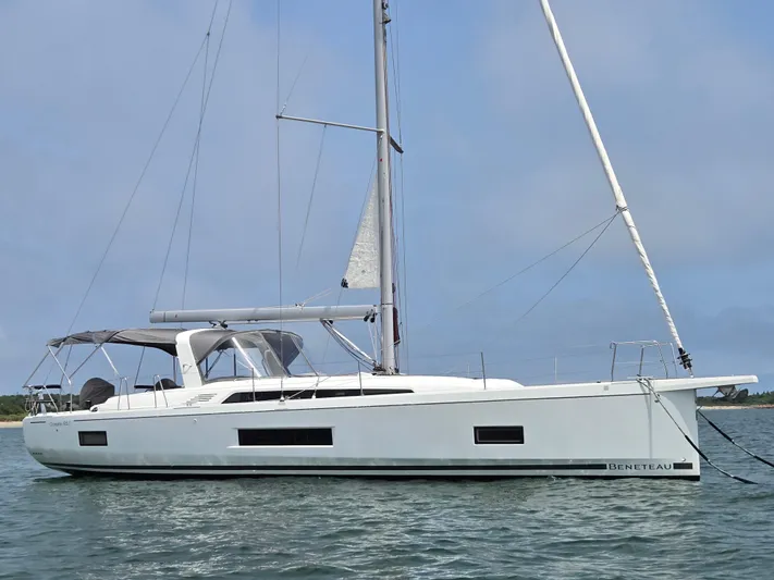 Off-piste Yacht Photos Pics 2019 Beneteau Oceanis 46.1 sailboat on calm water, side view.