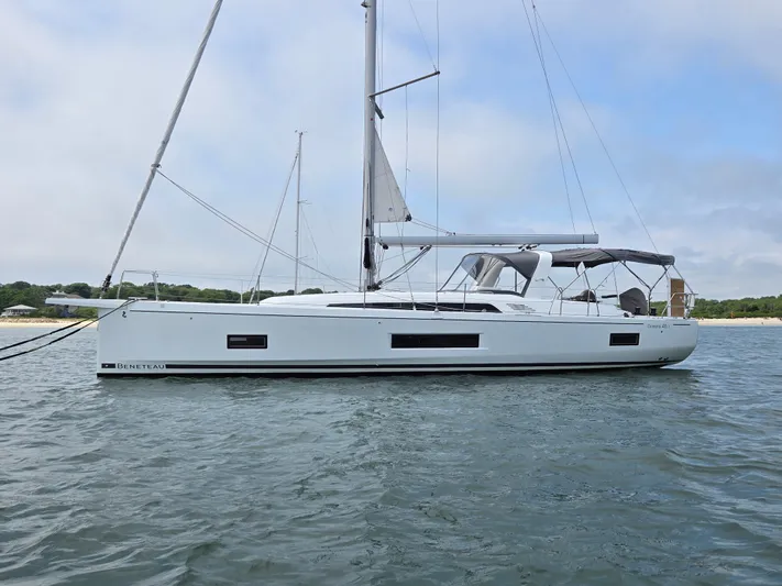 Off-piste Yacht Photos Pics 2019 Beneteau Oceanis 46.1 sailboat on calm water, side view.