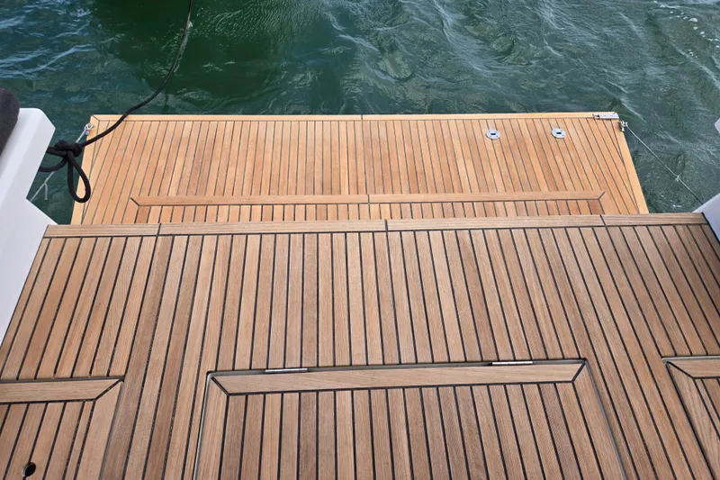 Off-piste Yacht Photos Pics Teak deck of 2019 Beneteau Oceanis 46.1 yacht with water view.