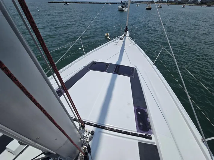 Off-piste Yacht Photos Pics 2019 Beneteau Oceanis 46.1 sailboat deck view, anchored in calm waters.