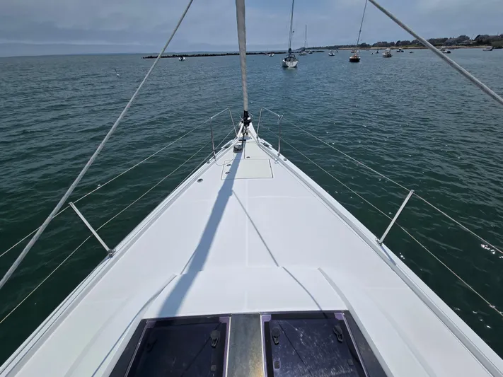 Off-piste Yacht Photos Pics Bow view of 2019 Beneteau Oceanis 46.1 sailing in calm waters.