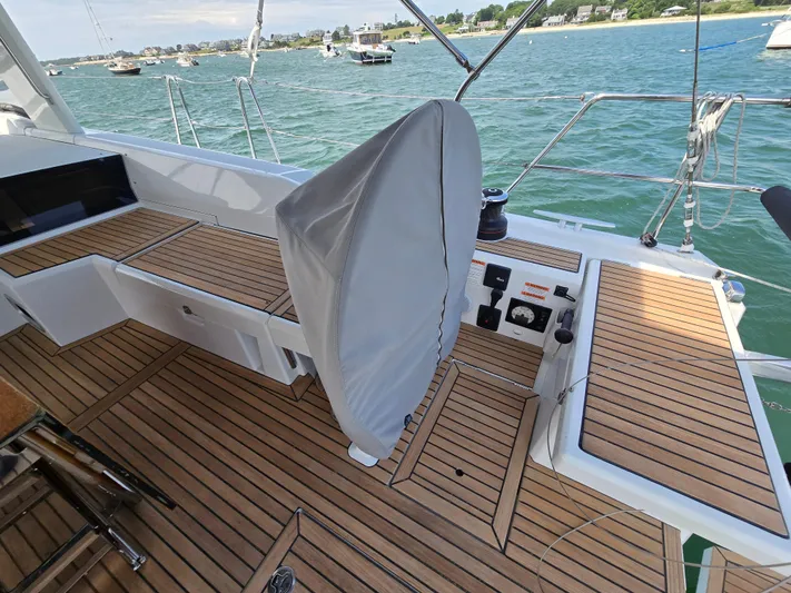 Off-piste Yacht Photos Pics Cockpit of 2019 Beneteau Oceanis 46.1 yacht with teak flooring and covered helm.