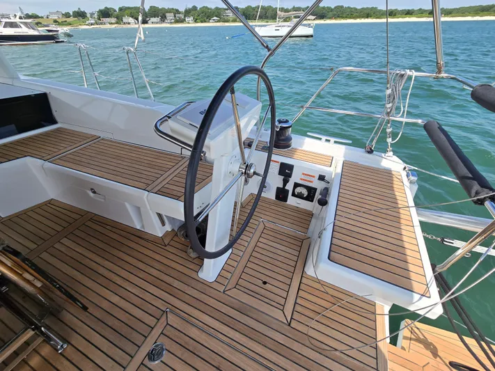 Off-piste Yacht Photos Pics Cockpit of 2019 Beneteau Oceanis 46.1 yacht with teak decking and steering wheel.