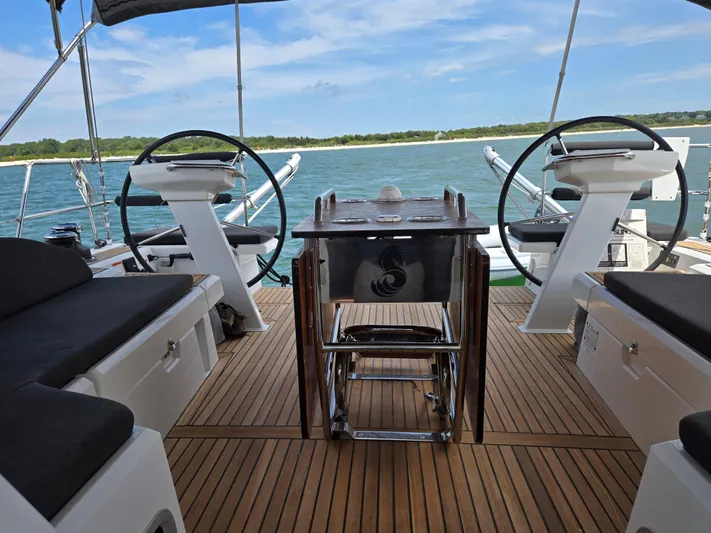Off-piste Yacht Photos Pics 2019 Beneteau Oceanis 46.1 yacht cockpit with dual steering wheels and wooden deck.