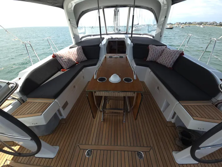 Off-piste Yacht Photos Pics Spacious cockpit of 2019 Beneteau Oceanis 46.1 yacht with comfortable seating and wooden table.
