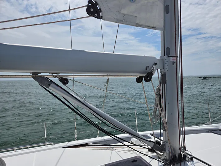 Off-piste Yacht Photos Pics 2019 Beneteau Oceanis 46.1 sailboat mast and boom on open water.