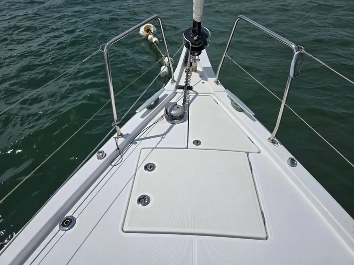 Off-piste Yacht Photos Pics Bow of 2019 Beneteau Oceanis 46.1 sailboat on water, featuring deck and railing.