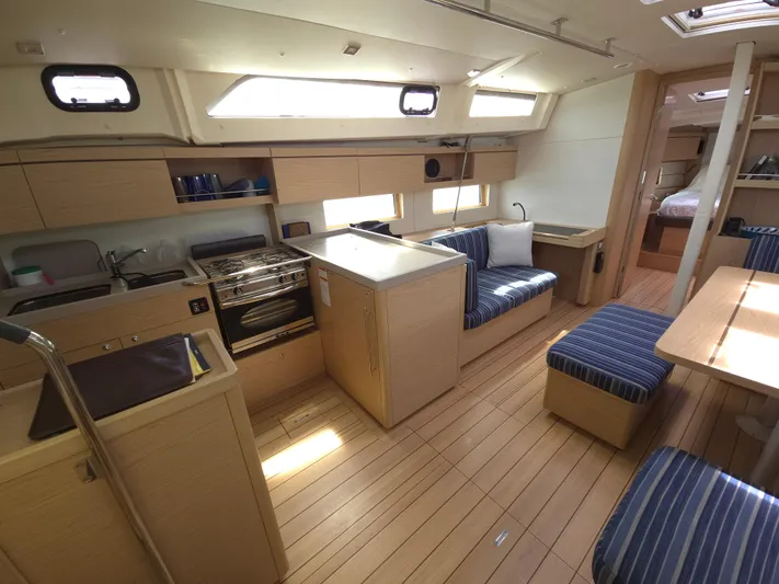 Off-piste Yacht Photos Pics Interior of 2019 Beneteau Oceanis 46.1 yacht with modern kitchen and seating area.