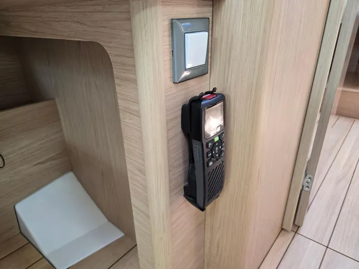 Off-piste Yacht Photos Pics Interior of 2019 Beneteau Oceanis 46.1 yacht with mounted radio and light switch.