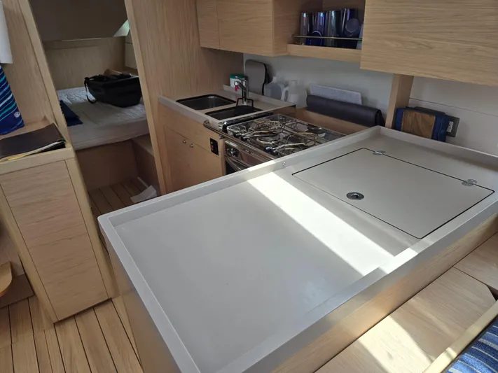 Off-piste Yacht Photos Pics Interior of 2019 Beneteau Oceanis 46.1 yacht, featuring modern kitchen and cozy cabin space.