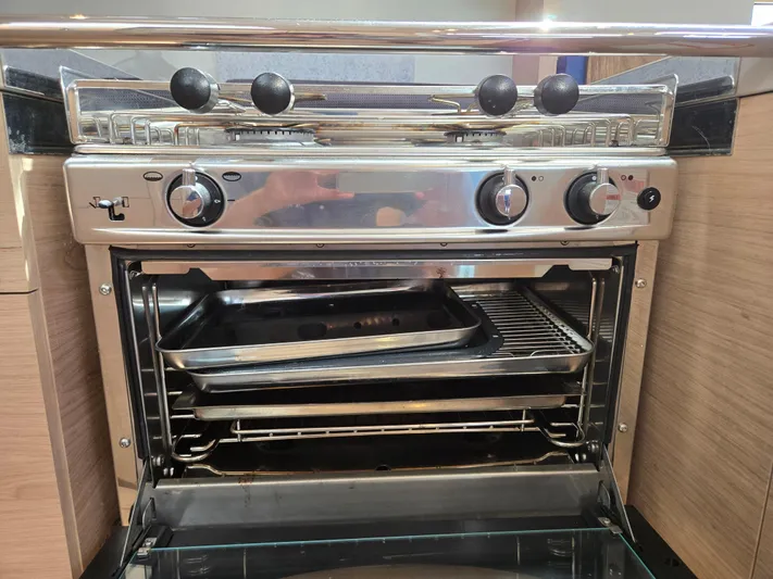 Off-piste Yacht Photos Pics Stainless steel oven with trays in a 2019 Beneteau Oceanis 46.1 yacht kitchen.