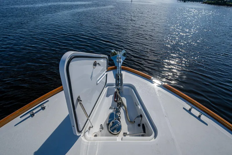 Oldielox 2 Yacht Photos Pics Hinckley T55 MKII Motor Yacht 2019 bow with open hatch, on calm water.