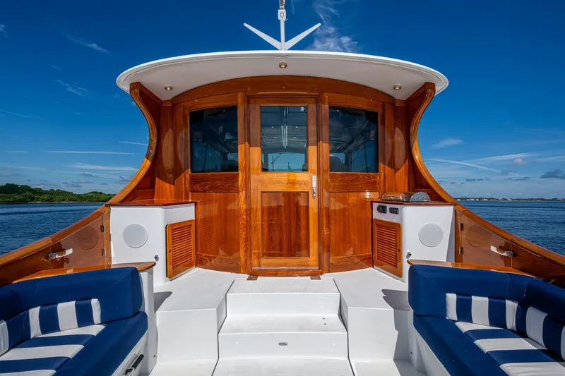 Oldielox 2 Yacht Photos Pics Luxurious 2019 Hinckley T55 MKII Motor Yacht with elegant wood finish and blue seating.