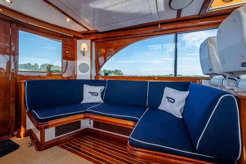 Oldielox 2 Yacht Photos Pics Luxurious interior of 2019 Hinckley T55 MKII Motor Yacht with blue seating and wooden accents.