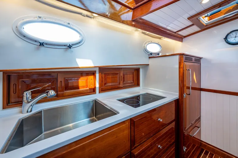 Oldielox 2 Yacht Photos Pics Luxurious kitchen interior of 2019 Hinckley T55 MKII Motor Yacht with wood finish.