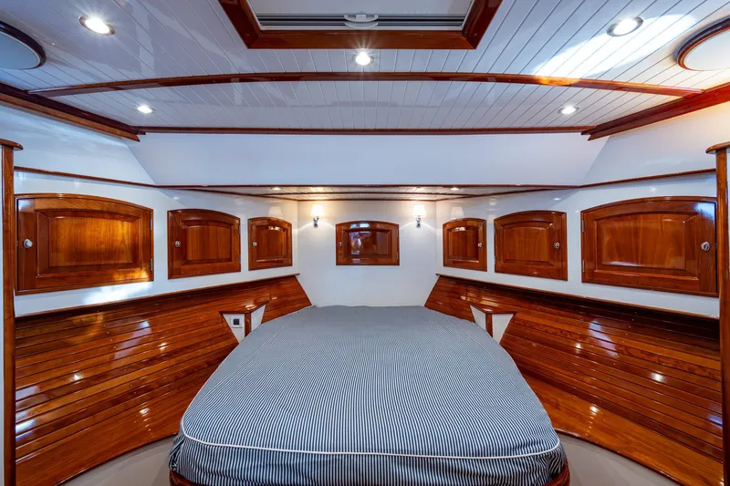 Oldielox 2 Yacht Photos Pics Luxurious 2019 Hinckley T55 MKII Motor Yacht cabin with elegant wood paneling and cozy bed.