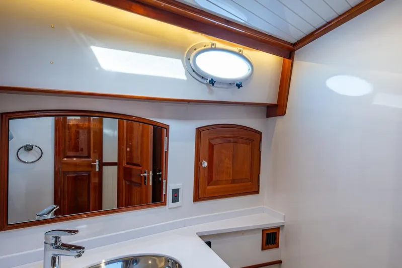 Oldielox 2 Yacht Photos Pics Luxurious bathroom interior of 2019 Hinckley T55 MKII Motor Yacht with wooden accents.