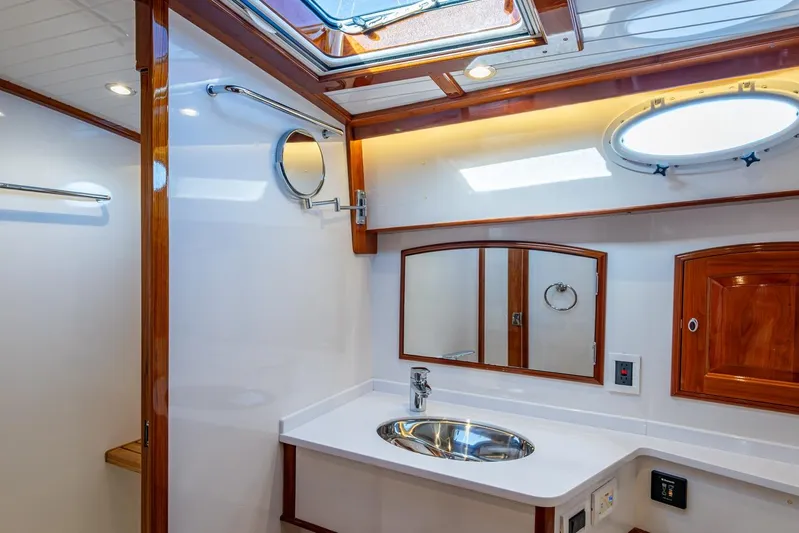 Oldielox 2 Yacht Photos Pics Luxurious bathroom interior of 2019 Hinckley T55 MKII Motor Yacht with wood accents.